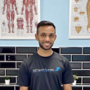 A photo of Nikhil Dodhia smiling and wearing a black t-shirt