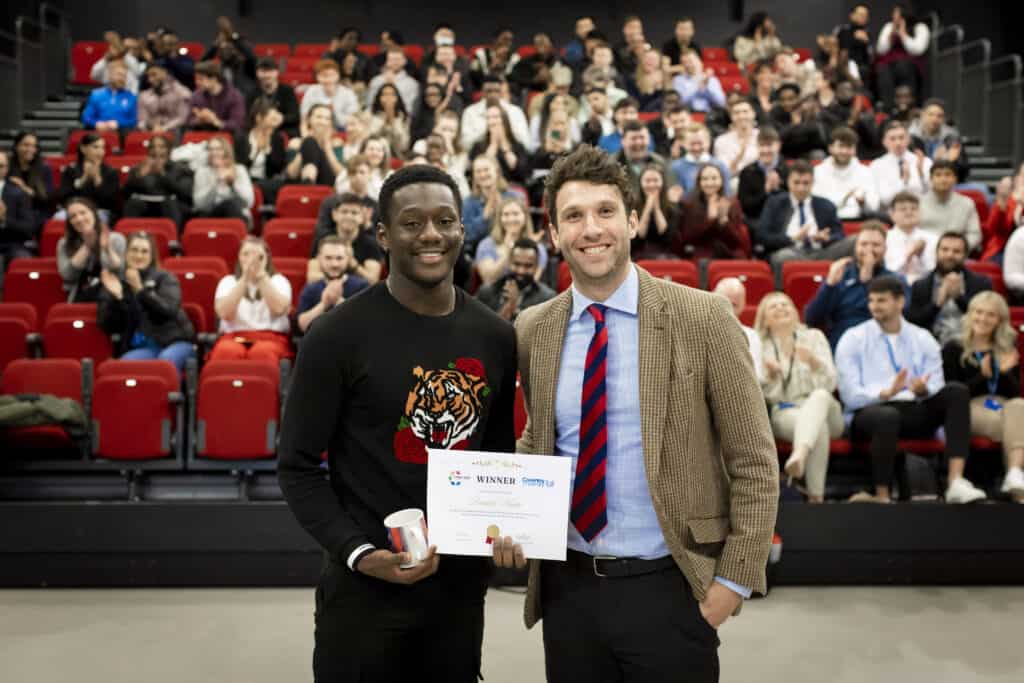 The BSc Sport and Exercise Science Course Director presenting the winner of the award with a certificate and prize